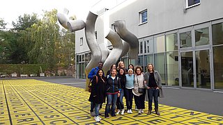 students infront of a sculpture