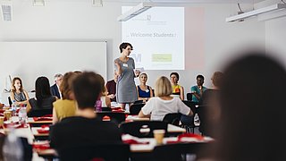 students in the classroom listening International Office staff's presentation