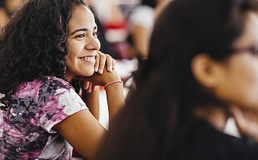 Portrait of a smiling student during a lecture that is part of the Master of Arts Social Work as a Human Rights Profession